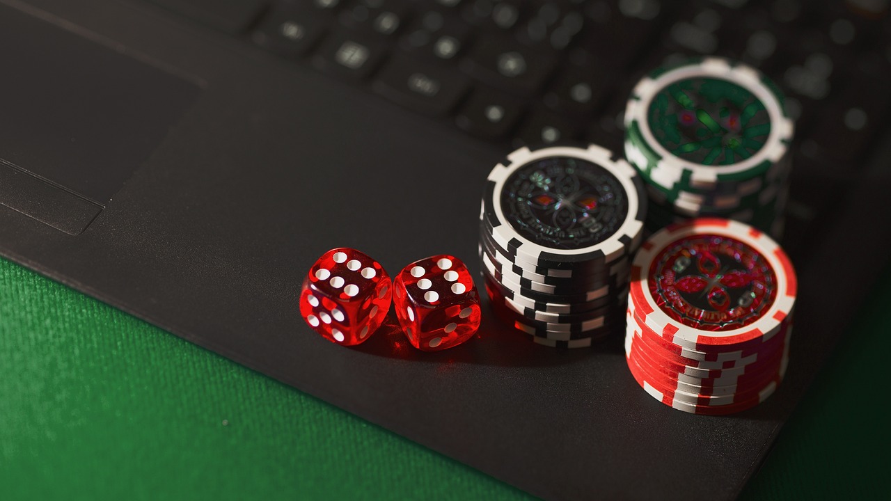 Digital casino chips, dice and keyboard representing online casinos